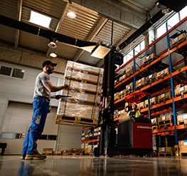 low angle view happy warehouse workers communicating while working with shipment industrial storage compartmen