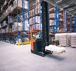 worker operating forklift machine relocating goods large warehouse center